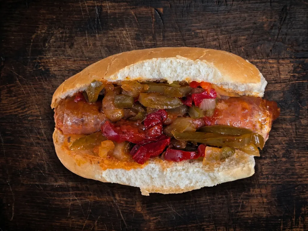 Ricci's famous hot Italian sausage sandwich with marinara sauce on a Mancini's roll